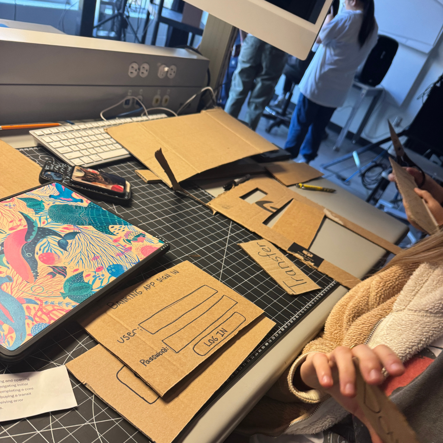 After assigning our roles, we all make different components of our app out of cardboars. 